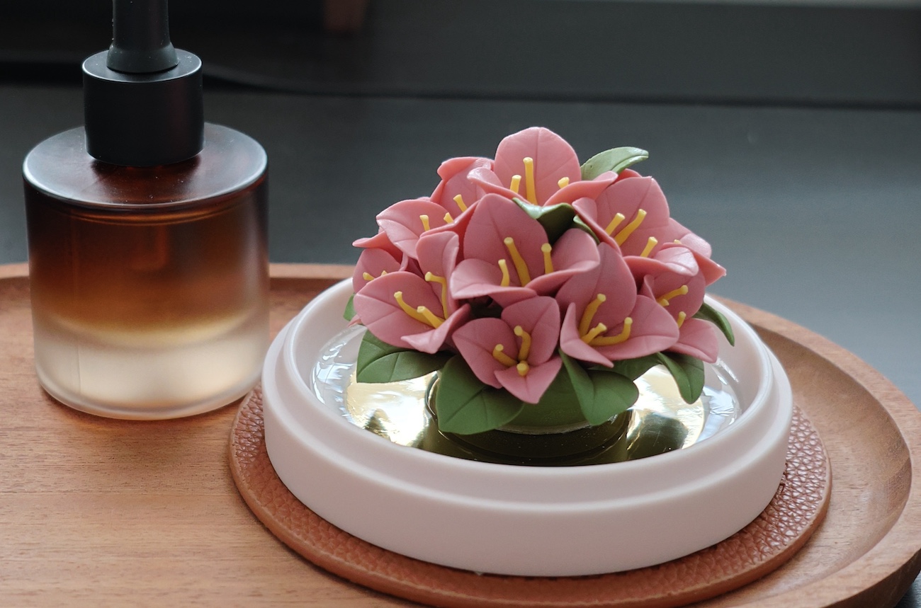 Vibrant pink porcelain Bougainvillea diffuser, meticulously crafted for cold diffusion of essential oils, serving as a permanent art piece for modern interiors.